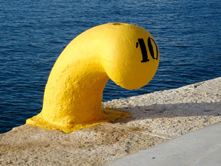 close-up of a yellow bollard harbor