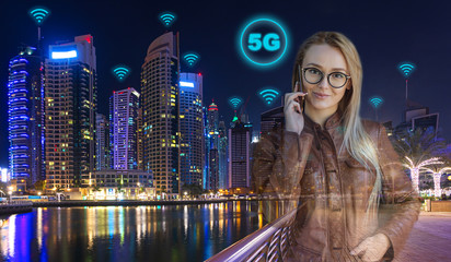 Double exposure of smart business woman with modern city in background at night using 5G speed...