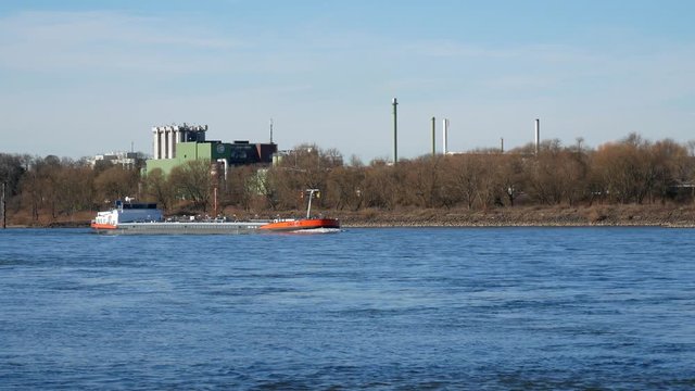 Leverkusen, Germany - May 22, 2019: Container ship on river rhine in Germany near Leverkusen and Bayer company