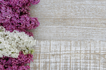Background of lilac flowers on a wooden surface