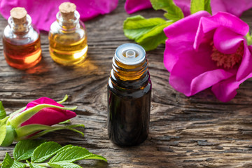 A bottle of essential oil with Rugosa roses