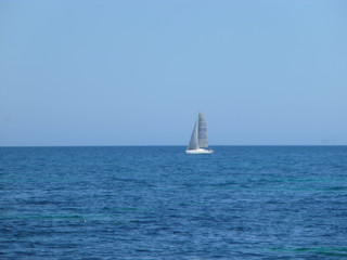 sailboat sailing in the mediterranean sea on the horizon