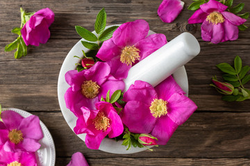 Fresh rosa rugosa flowers in a mortar