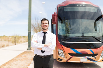 Smiling Driver In Uniform with Bus Behind