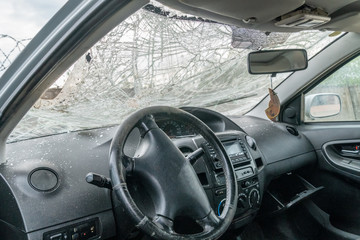 View of the inside of the car with cracks on the windshield due to damage due to an accident.
