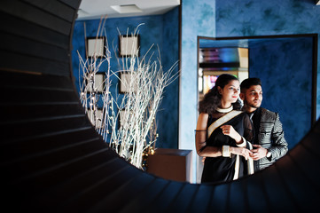 Lovely indian couple in love, wear at saree and elegant suit, posed on restaurant at round circle...