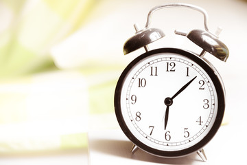 Alarm clock - vintage  classic alarm clock next to bed in bedroom