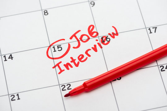close up of print calendar with red mark and job interview lettering