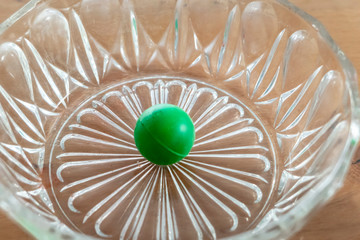 green ball in a noble glass bowl