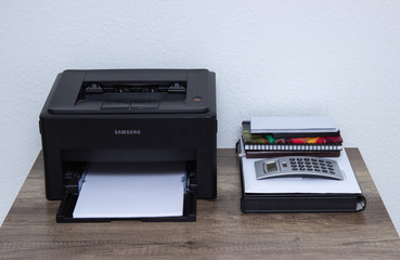 Laser printer and office supplies on the table.