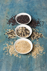 Bowls with uncooked black and white rice