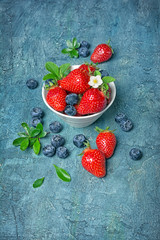 Fresh berries strawberries and blueberries with leaves and flower