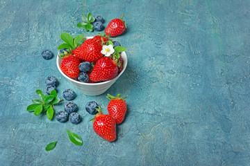 Fresh berries strawberries and blueberries with leaves and flower