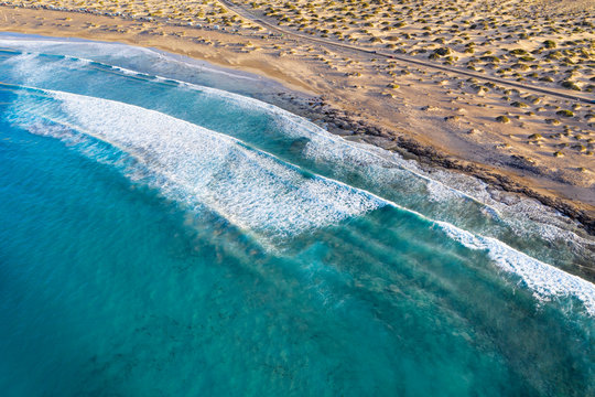 Spain, Canary Islands, Lanzarote, Caleta de Famara, Playa de Famara, waves on sandy beach, aerial view