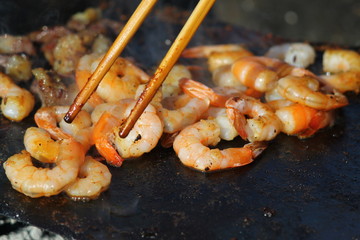 Shrimps on the pan with chopsticks