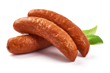 Smoked pork sausages with basil leaves, dry meat, close-up, isolated on white background