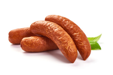Bavarian Smoked Sausages with basil leaves, dry meat, close-up, isolated on white background