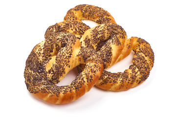 Appetizing Bavarian pretzel with poppy seeds, close-up, isolated on white background