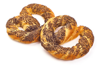 Freshly baked soft pretzel with poppy seeds, close-up, isolated on white background