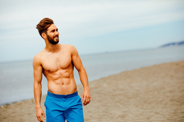 Handsome man posing on the beach