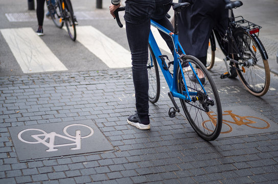 Young cyclists waiting for green light in a cycle symbol marked lane in Oslo, Norway.