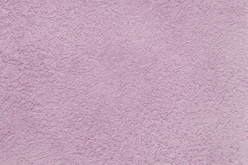 background of an old embossed plastered pink painted wall close up