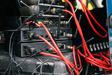 Connecting microphones. Base for microphones with connected red wires. Microphones and radio systems. Musical equipment at a concert or even