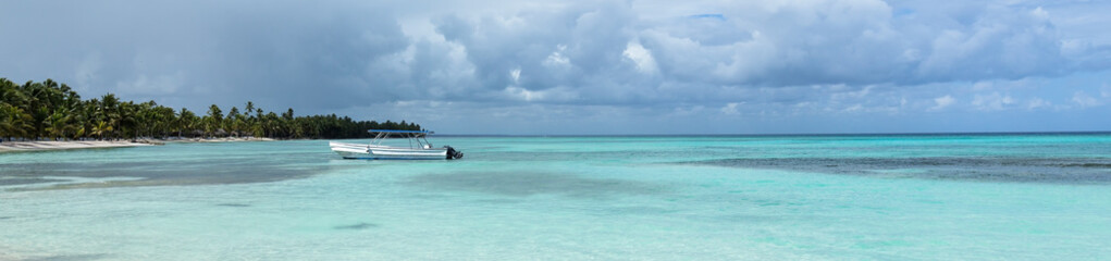 Obraz na płótnie Canvas White sandy beach with sea and boat