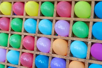 Colored balloons dart game background. Playgame is throwing darts into colorful ballon, entertainment in the park for children.