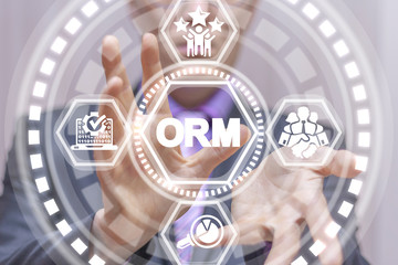 Manager uses on a virtual screen of the future and uses the acronym: ORM. Online Reputation Management Optimization Business concept.