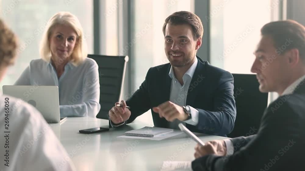 Canvas Prints Businessman in suit talking to business people sitting at table