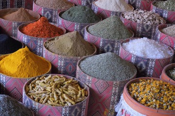 colorful spices: red, yellow, green, black, grey, brown spices in round boxes in the form of slides. colorful spices on the east the market