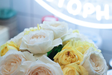 Obraz na płótnie Canvas wedding rings on a bouquet of white roses