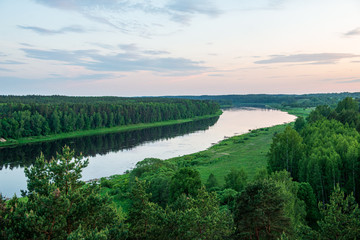 scenic river view landscape of forest rocky stream with trees on the shores