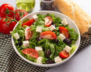 Greek Salad with Olives Tomatos and Feta Cheese on a Concrete Countertop