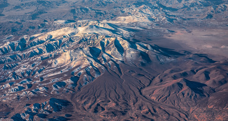 Aerial View from an Airplane. Flying above Beautiful Land at Sunrise.