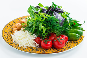 A plate of fresh Baku vegetables: tomatoes, cucumbers, greens, cabbage, cheese