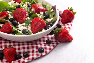 Bright Garden Salad with Fresh Fruit on a Red Gingham Tablecloth