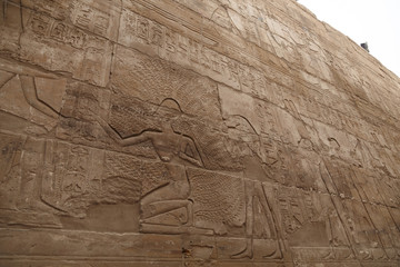 Wall with hieroglyphs of Karnak Temple in Luxor, Egypt. The temple complex at Karnak includes many...