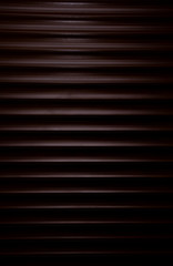 Obraz premium Detailed shot of wooden blinds dramatic light. Background, texture of brown shutter home pattern