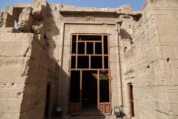 Building with hieroglyphs inside of The Temple of Horus at Edfu, Egypt. The temple complex of Horus includes many ancient monuments and columns of the ancient Egyptian civilization