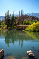 Fototapeta premium Clear lake among the mountains with a little house