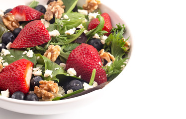 Bright Garden Salad with Fresh Fruit Isolated on a White Background