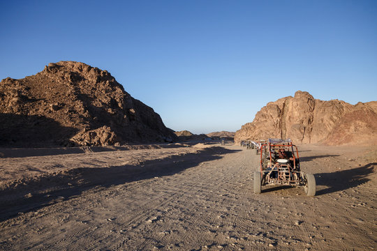 Extreme buggy races at sunset near the mountains and a Bedouin village in the desert near Hurghada. Egypt