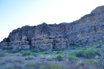 Rugged rock face in desert shadow