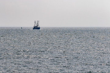 small Fishing cutter on the open ocean in the north sea in germany 