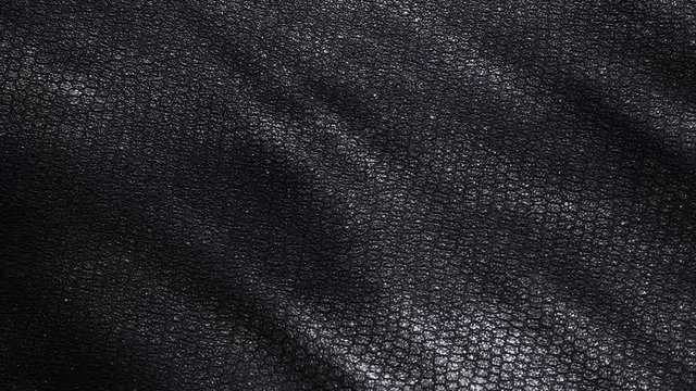 Waving rough, grungy leather texture. Old, vintage animal skin surface material close up shot.