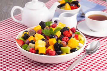 Table Set for Breakfast with Fresh Fruit Salad on a Red Plaid Table Cloth
