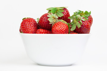  RED STRAWBERRIES WITH GREEN LEAVES IN BOWL ON WHITE BACKGROUND