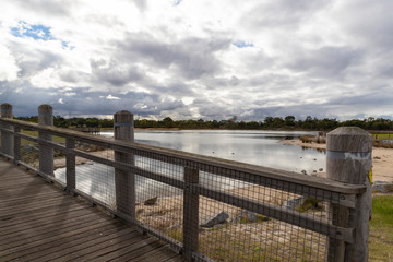 Fototapeta premium A walk bridge on a large fresh water lake in a community park.